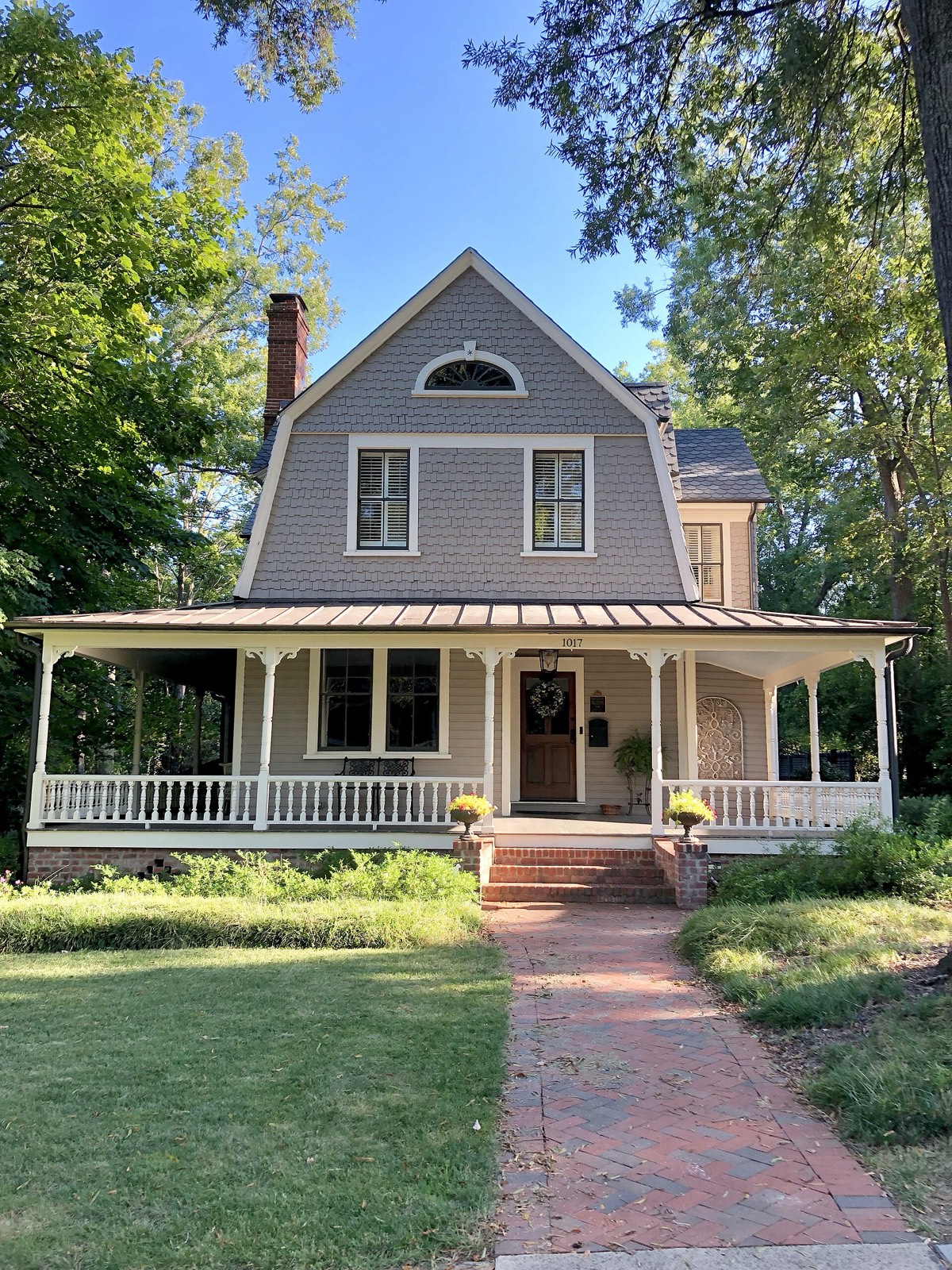 Period house behind mature trees