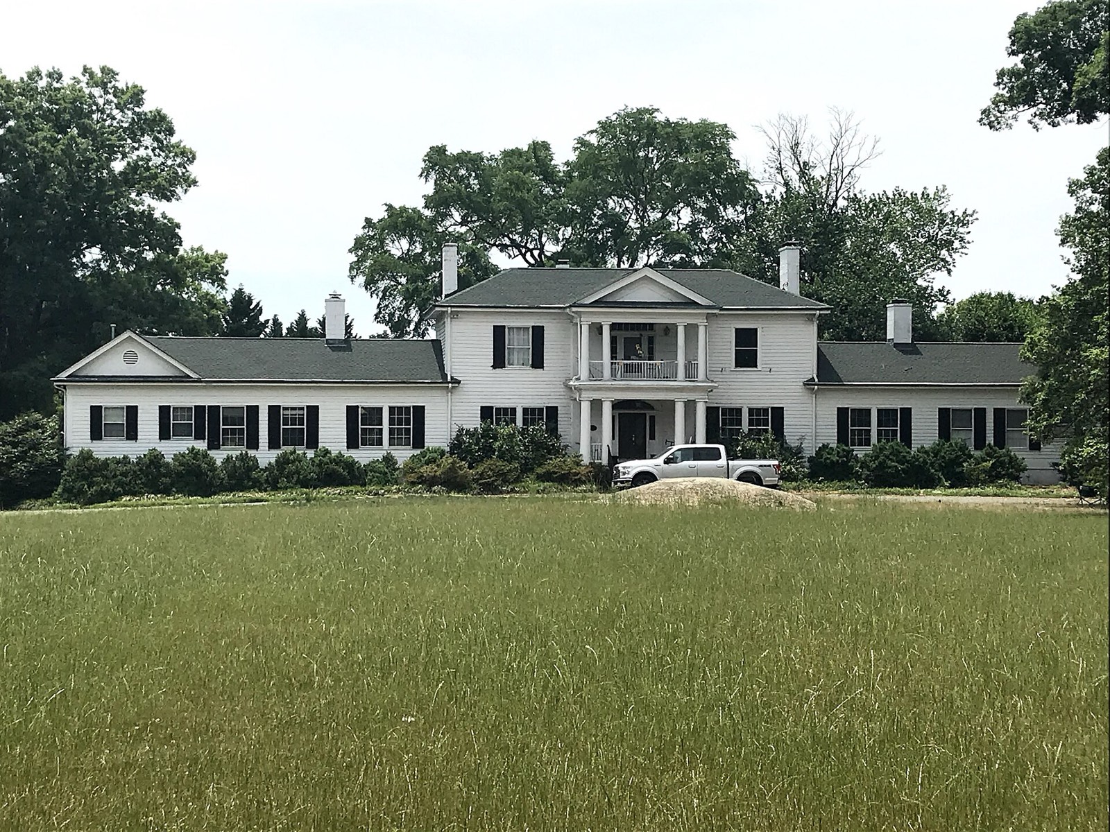White clapboard residence on open lawn